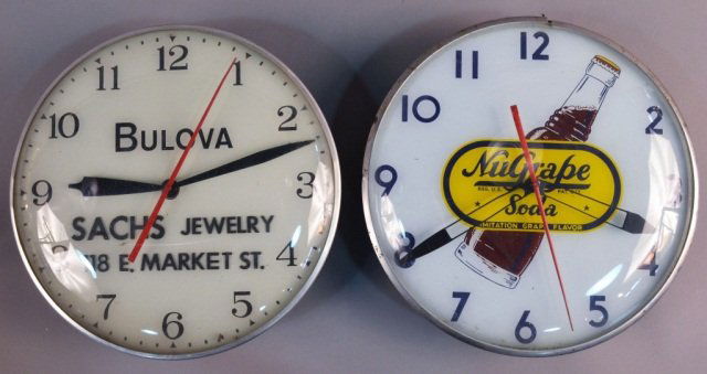 Two Advertising Clocks: Bulova, Sachs Jewelry and NuGrape Soda. Diameter 15 inches.