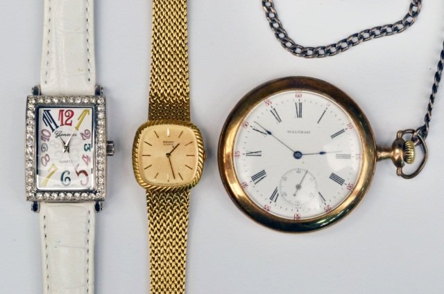 Three Watches: Waltham gold filled pocketwatch and watch chain, a Seiko Quartz wrist watch and a Genevex Quartz wrist watch with a white leather band.