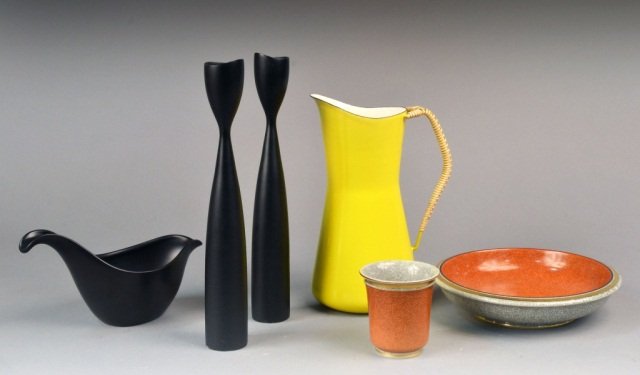 Collection of Modernist Tablewares: Comprising a Danish Modern yellow-and white enameled ewer with braided handle, designed by Jen Qvistgaard, height 10 inches; a pair of Danish Modern ebonized wood candlesticks, height 11 1/2 inches; a
