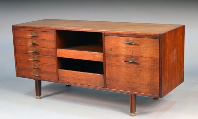 Manner of George Nelson Teak Credenza: Rectangular top over two sliding open shelves flanked by drawers. Height 27 inches, width 58 1/2 inches, depth 20 inches.