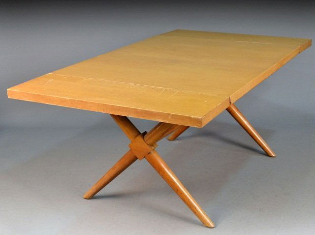 Blond Wood Drop Leaf Dining Table: Rectangular top with two drop leaves on X form trestle base. Height 29 1/2 inches, width extended 6 feet, depth 40 inches.