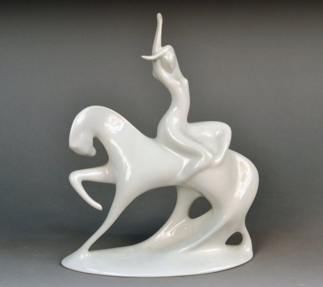 Royal Dux White Porcelain Figure: Depicting a woman seated backwards on a horse. Height 14 inches.