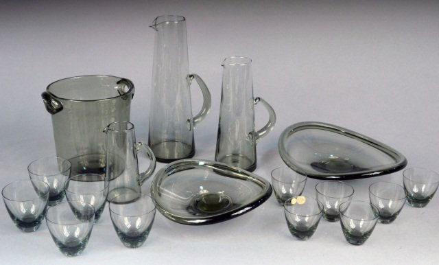 Group of Danish Modern Smoked Glass Articles: Designed by Per Lutken for Holmegaard. Comprising three graduated cocktail pitchers in the "Martini" pattern, height 6 inches 1 11 1/2 inches; five cocktail glasses and six glasses in the "