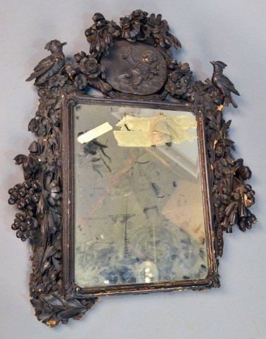 Carved Wood Mirror: Black forest style carving of birds, flowers, fruit and ribbons. Height 39 inches, width 31 inches.