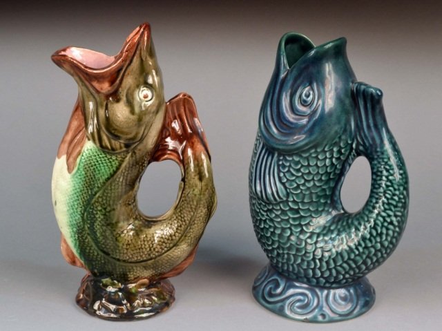 Two French Faience Pitchers: Each modeled as fish with mouth spout, one by Onnaing, the other marked Saint Radegonde. Taller height 11 inches.