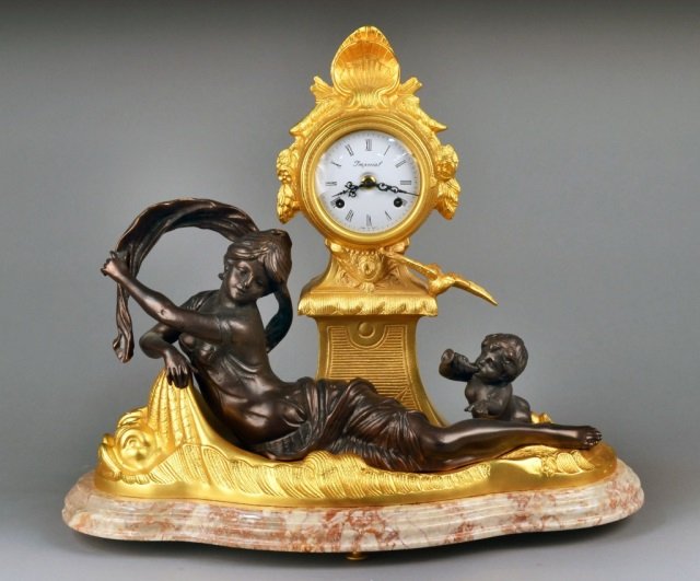 German Figural Clock: Cupid and psyche figural decoration, on a rouge marble base. Height 18 inches.