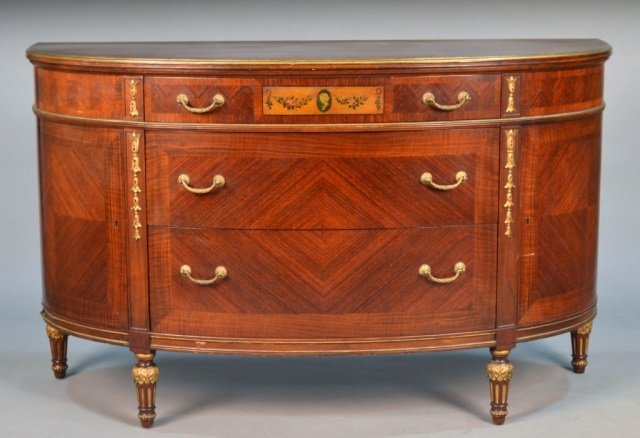 George III Style Demilune Commode: D-shaped top over three graduated drawers, tapered legs. Height 35 inches, width 57 inches, depth 22 inches. Property from a Distinguished New York Collection.