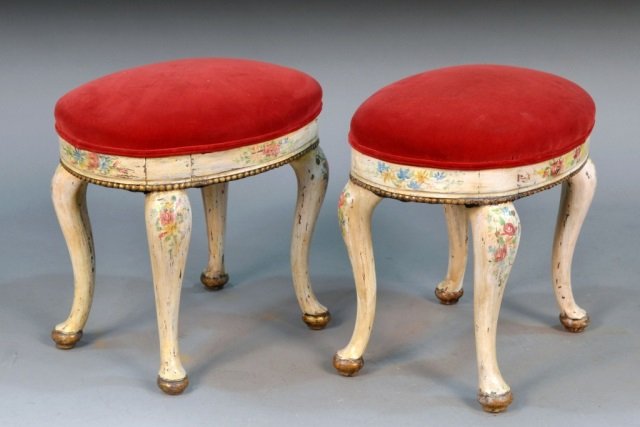 Pair of Venetian Painted Stools: Each with red velvet upholstered seat on a polychrome floral painted cabriole legs. Height 20 inches, width 19 inches, depth 14 inches.