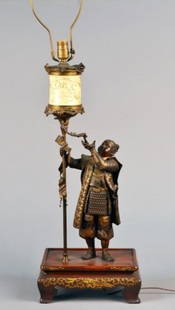 Japanese Bronze Figural Lamp: A man standing, holding a carved ivory lantern. Height 28 inches. Property from a Distinguished New York Collection.