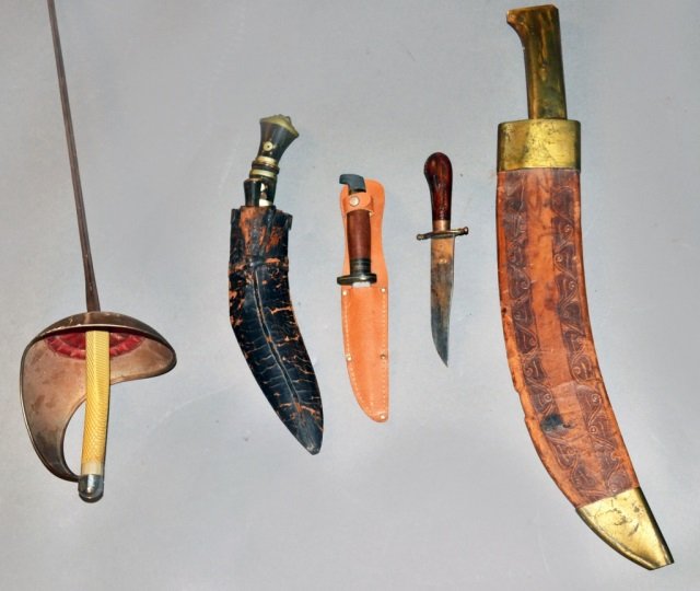 Group of Four Knives and a Sword: Including a kukri, machete, two knives, and a fencing foil. Foil blade length 32 3/4 inches. Provenance: Estate of Leo Barrile, Leo's Antiques in Bensonhurst NY