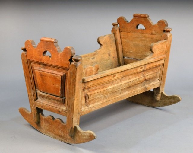 English Elizabethan Cradle: 17th century. Height 26 inches, width 37 inches, depth 21 inches.