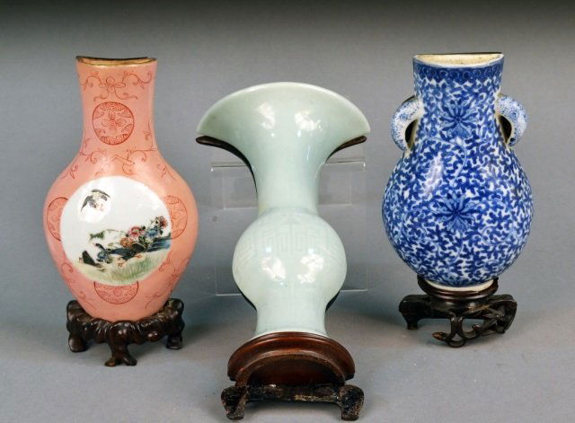 Three Chinese Porcelain Wall Pockets: Each, urn form with a wood back plate. (1) blue and white painted; (2) pink decorated; (3) celadon. Celadon wall pocket height 9 inches. Ex Collection of Rose Schiffman Tanner. Emigrated from Russia t