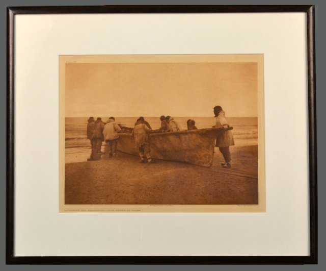 Edward Sheriff Curtis (American, 1868-1952): Launching the Whaleboat - Cape Prince of Wales. Vintage Photogravure, original image circa 1928, printed by John Andrew & Son and Suffolk Engraving Co. Credited (l.c.), copyrighted (l.r.), titled (l.l
