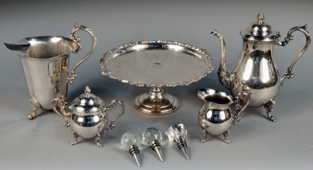 Miscellaneous Group of Silver Plated Articles: Comprising a coffee pot, cream and sugar, a water pitcher, cake stand and bottle stoppers.