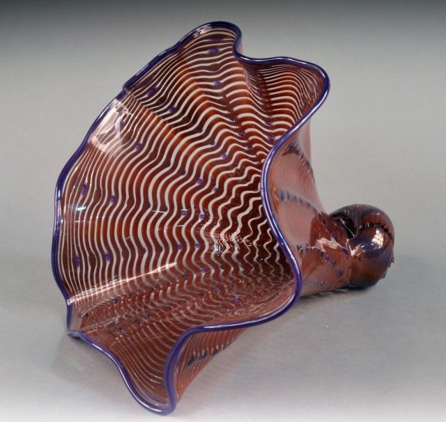 Manner of Dale Chihuly (American, 1941) Cornucopia: Late 20th century. Art glass cornucopia. Purple and orange decoration. Signed, dated 2004, numbered "5023". Height 11 inches.