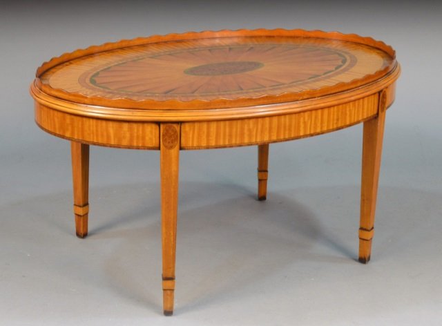 Edwardian Inlaid Satinwood Oval Low Table: Oval, inlaid top with scalloped gallery, square tapered legs. Height 20 inches, width 37 1/2 inches, depth 25 1/2 inches.
