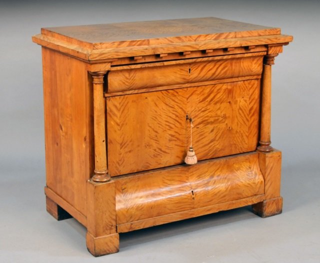 Biedermeier Flame Birch Commode: Circa 1830, rectangular stepped top over three drawers flanked by a pair of tapered columns. Height 32 1/2 inches, width 36 1/2 inches, depth 21 3/4 inches.