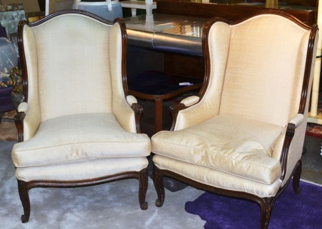 Pair of Louis XV Style Wing Back Bergeres: Fruitwood with white fabric upholstered back and cushion, padded arms, on four cabriole legs. Height 43 inches, width 27 inches, depth 27 inches.