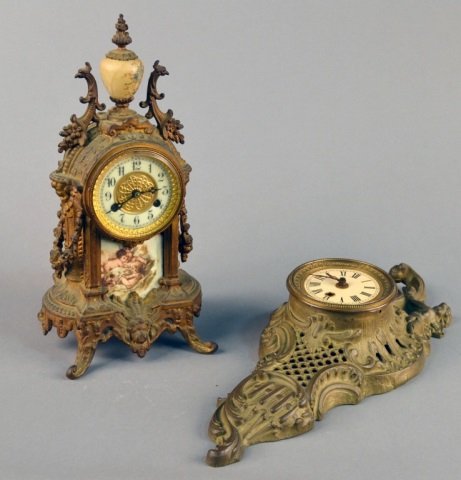 Two Metal Cased Clocks: One a German cartel style with scroll decoration, the other a renaissance revival style enamel chapter ring. Cartel clock height 17 inches.