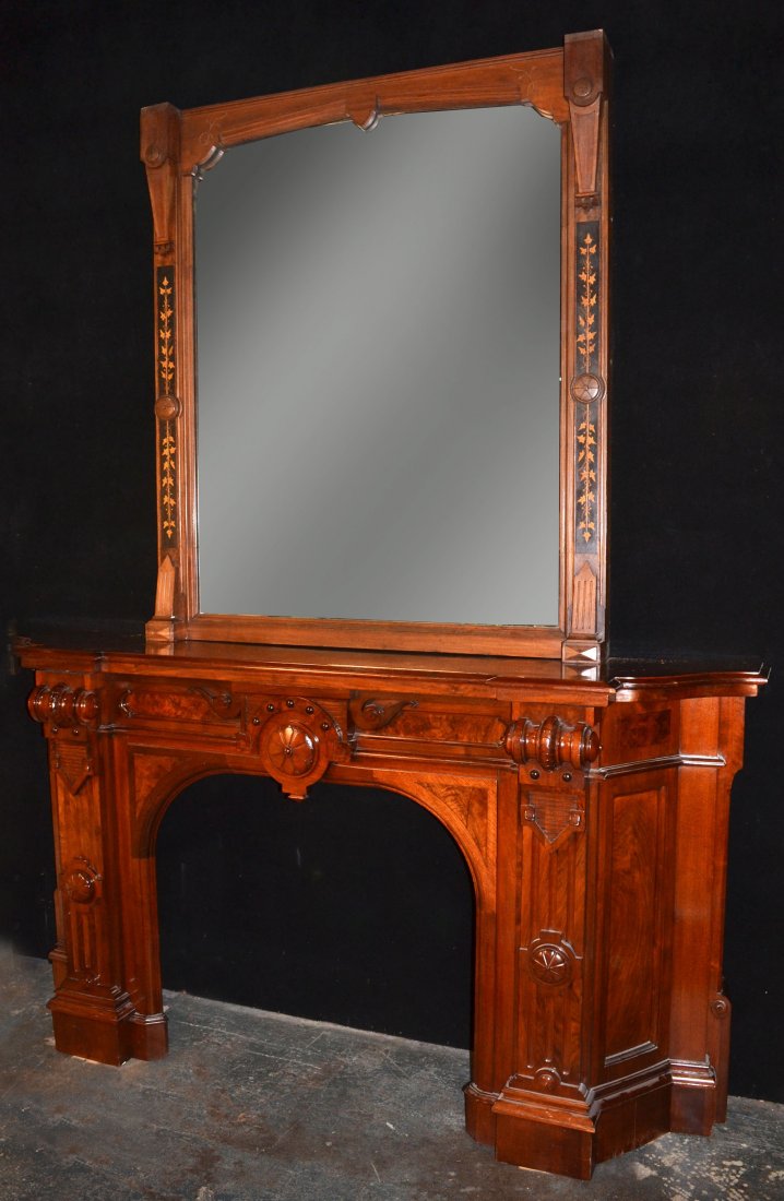 Mahogany Fireplace Surround and Mirror: 19th century, fireplace surround with carved scroll and rosette decoration, height 48 inches, width 7 feet 7 inches,depth 21 1/2 inches; the mirror with inlaid vines of ivy, 63 x 55 inches.
