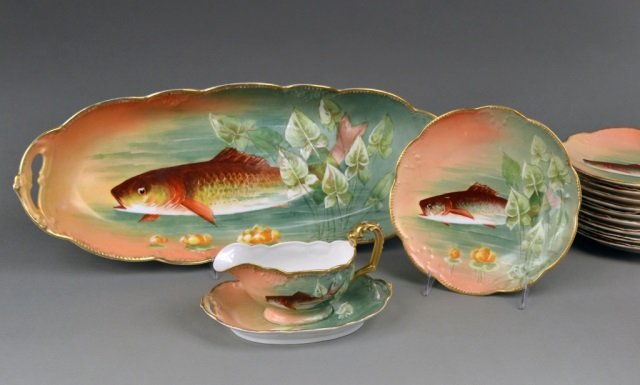Limoges Porcelain Fish Service: Comprising ten fish plates, a sauce boat with underplate, and a fish platter, signed NABA.
