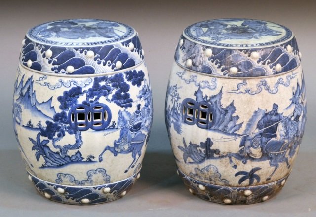 Chinese Blue and White Porcelain Garden Seats: Each with all around decoration of warriors on horseback. Height 17 inches, diameter 15 inches.