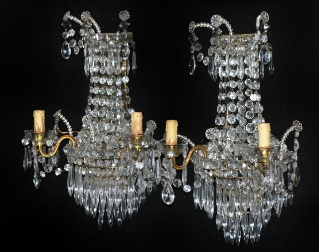 Pair of Neoclassical Style Three Light Sconces: Each with mirrored back, bead ropes, and adorned with prisms. Height 17 inches, width 13 inches.