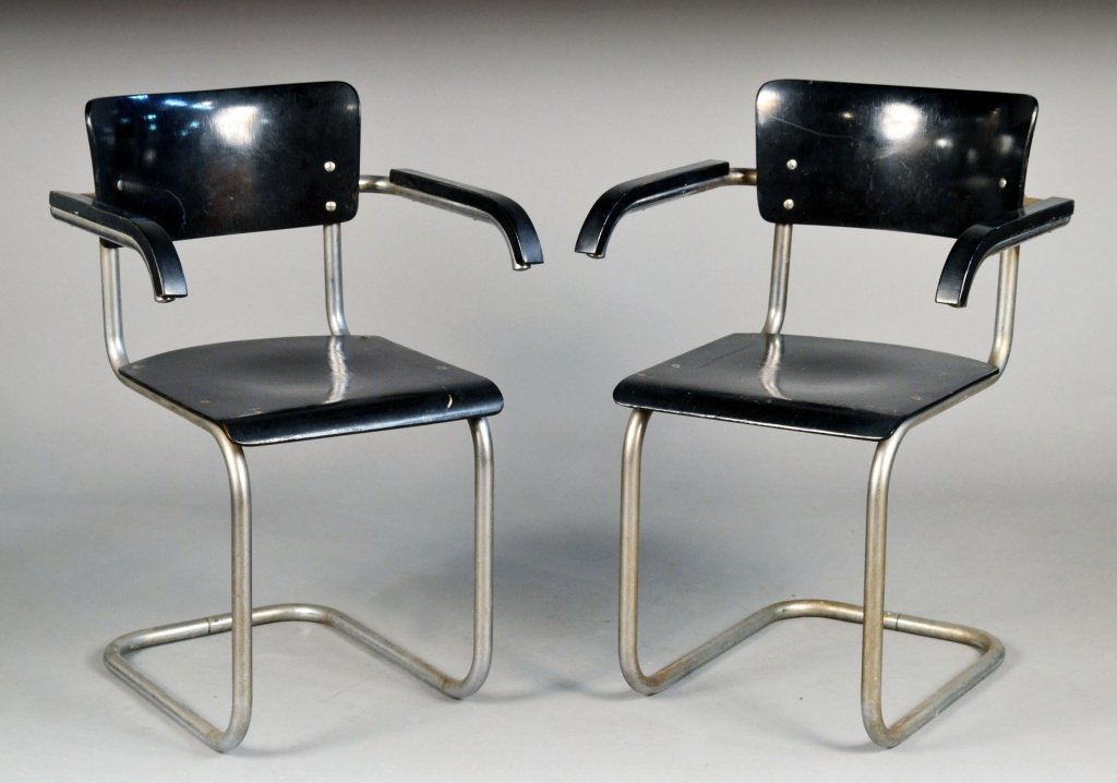 Pair of Marcel Breuer Cesca Armchairs: Each with black painted wood back, arm rests, and seat, tubular metal frame. Height 32 inches, width 21 inches, depth 20 inches. Provenance: Purchased in Germany in 1930's