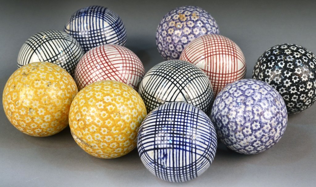 Twelve Ceramic Game Balls: Geometric and stylized floral decoration. Diameter 3 inches.