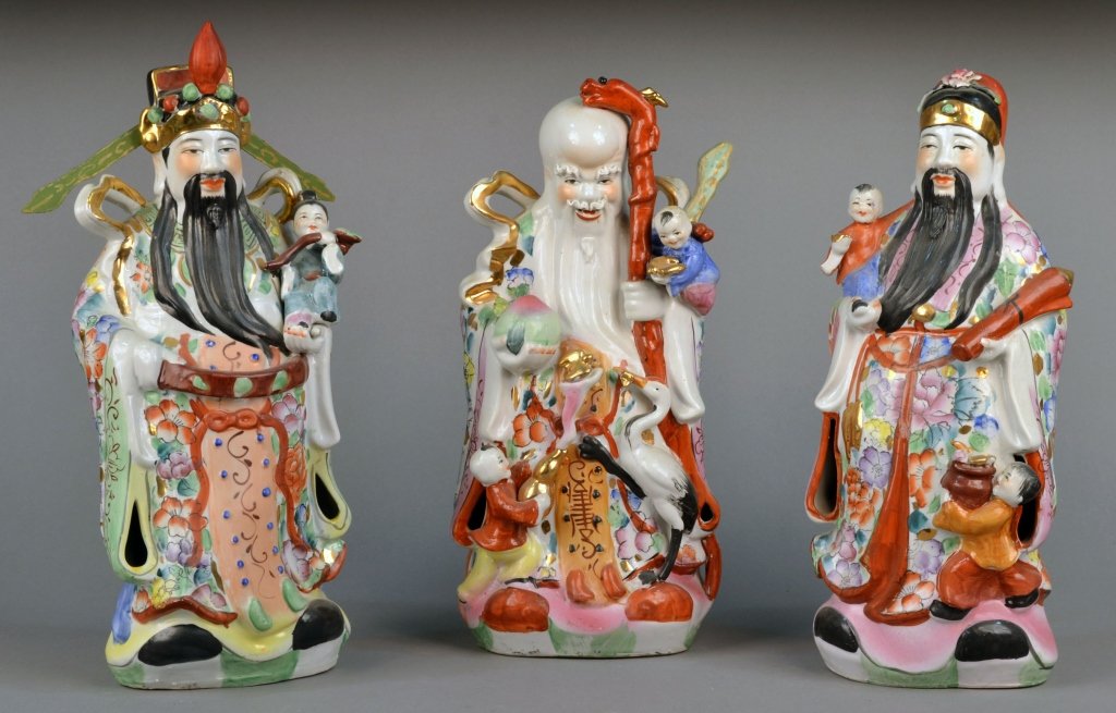 Set of Three Chinese Porcelain Figures: Depicting three men holding various items and children. Tallest height 17 1/2 inches. Provenance: Estate of Leo Barrile, Leo's Antiques in Bensonhurst NY
