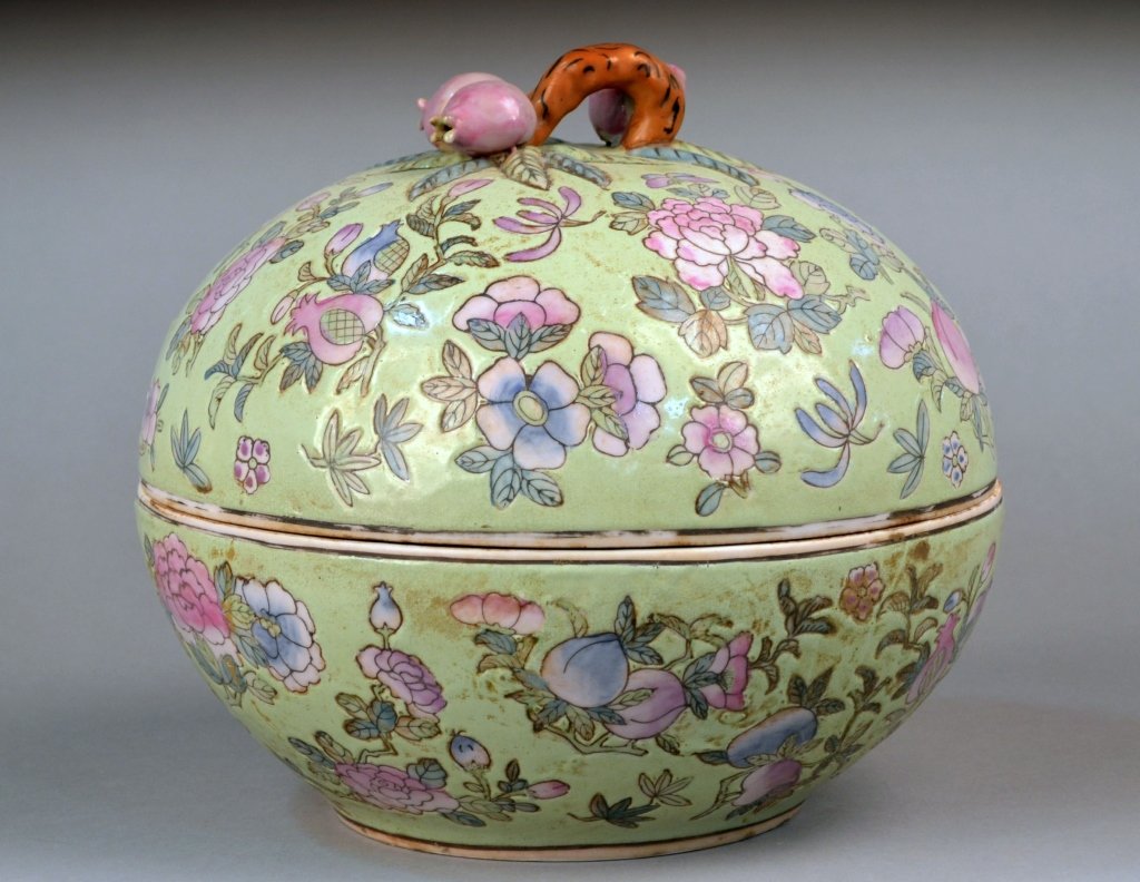 Asian Porcelain Covered Box: Flower and fruit decoration on light green groundm fruit finial. Height 9 1/2 inches, diameter 10 inches.