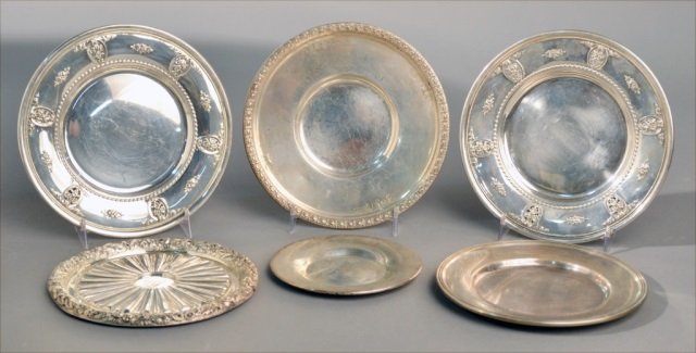 Six American Sterling Silver Circular Dishes: Various makers and patterns including a pair of Wallace Rose Point pattern bread plates, etc. Largest, diameter 6 1/2 inches, total 20.50 onces. Provenance: From a Gramercy Park estate.