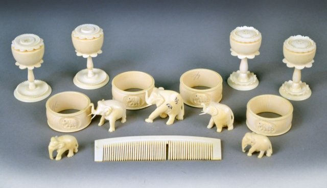 Group of Ivory Table Decorations: Including set of four shakers, four napkin rings, elephant figures, etc. Shakers, height 2 1/8 inches.