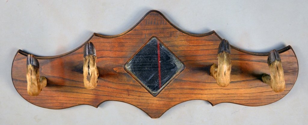 Animal Hoof Coat Rack: Four mounted deer hooves on a mirror inset wood panel Length 42 inches.