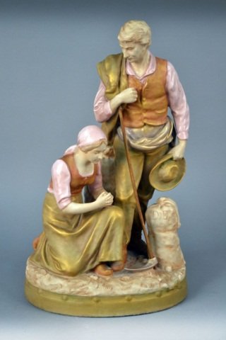 Royal Dux Porcelain Figure: Modeled as a couple with a dog, signed on the base. Height 18 1/2 inches.