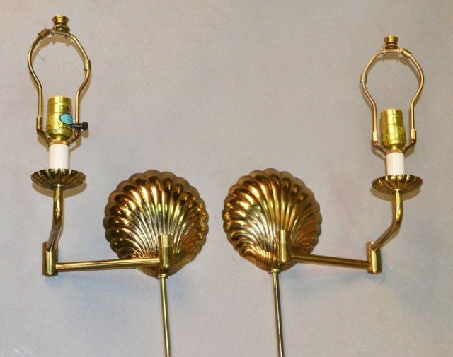 Pair of Stiffel Brass Sconces: Each a single light sconce with swing arm, shell form backplate, and brass cord enclosure. Height 45 inches.