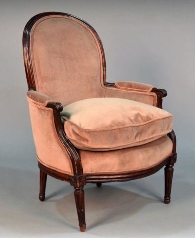 Louis XVI Walnut Bergere: Arched top, padded arms and bow front seat , on tapered fluted legs. Height 37 1/2 inches, width 28 inches,depth 28 inches.