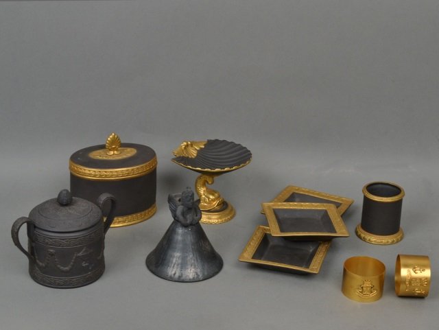 Miscellaneous Group of Black Basalt Decorations: Including an oval covered box, a shell form pedestal dish, three square trays, etc. Pedestal dish, height 3 1/2 inches.