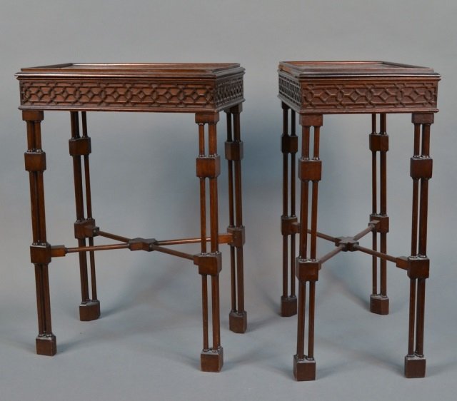 Pair of Mahogany Side Tables: Each with rectangular lift top with raised edge, on a closed fret carved apron, on triple pole turned legs joined by an X stretcher. Height 25 nches, width 16 1/2 inches, depth 10 1/2 inches.