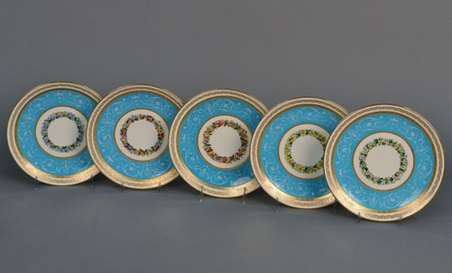 Set of Twelve Mintons Porcelain Cabinet Plates: Retailed by T. Goode & Co., London, each with a wreath of flowers within a celeste blue border with raised scroll white painted neoclassical decoration and gilt edge. Diameter 9 1/2 inches.
