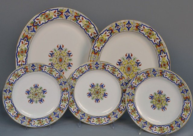 Royal Worcester Porcelain Service: Pattern, 8768, comprising twelve plates and two graduated platters. Plates, diameter 9 1/2 inches.