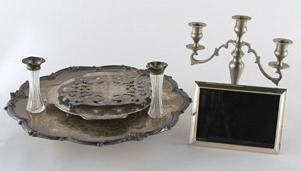 Group of Silver Table Articles: Including a sterling silver picture frame, a pair of sterling mounted vases, three silver plated trivets, and an English silver plated cruet set. Largest trivet, diameter 16 inches.