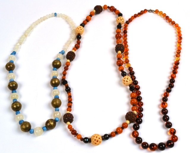 Three Bead Necklaces: One, with carnelian, amber and bone beads, length 32 inches; another with agate and turquoise beads, length 28 inches; and one amber necklace, length 32 inches.