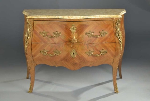 Louis XV Style Marble Top Commode: Gilt bronze mounted marquetry inlaid commode with serpentine fronted cream marble top over two conforming drawers, cabriole legs ending in sabots. Height 34 inches, width 48 inches, depth 21 inches.