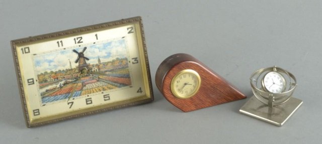 Three Table Clocks: One, dial painted with windmill and tulip fields, another with wood case, and another in the form of a gyroscope. Largest, 4 x 6 inches.