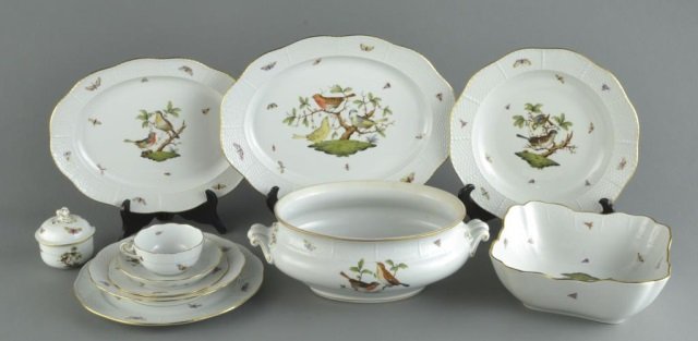 Herend Porcelain Dinner Service: Comprising twelve dinner plates, twelve salad plates, eleven bread plates, twelve soup plates, four cups and saucers and fifteen serving dishes. Dinner plate, diameter 10 inches.