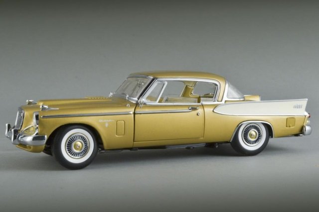 Signature Series 1958 Studebaker Goldenhawk Model: By Yat Ming, 1:18 diecast model, gold and white painted with finely detailed engine, movable steering, an operating antenna, and working side windows. Length 11 1/2 inches.
