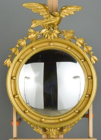 Federal Style Gilt Wood Convex Mirror: Circular convex plate surmounted by a spread winged eagle. Height 33 inches, width 24 inches.