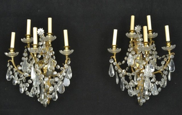 Pair of Louis XV Style Sconces: Each with five acanthus decorated arms with crystal swag decoration, and backplate with torch and swag decoration. Height 22 inches, width 17 inches.