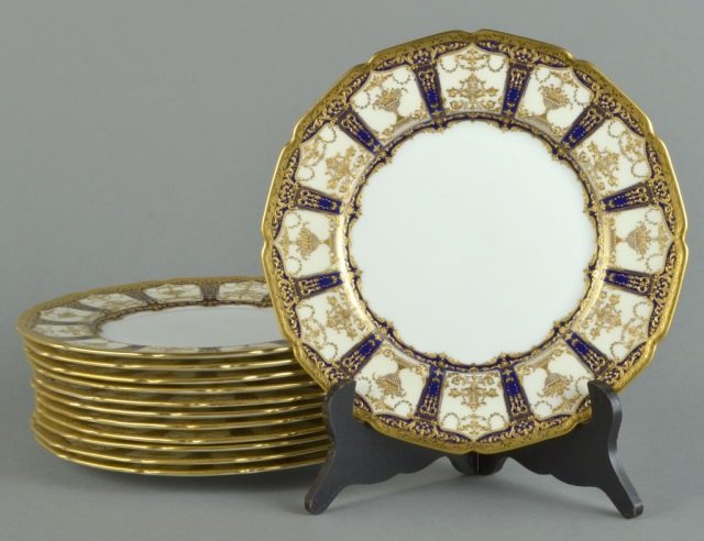 Set of Twelve Royal Doulton Service Plates: Cobalt and raised gold pattern H2149. Diameter 10 1/4 inches. Provenance: Descended in the family of Charles H. Ebbets, builder of Ebbet's Field in Brooklyn to the present owner.
